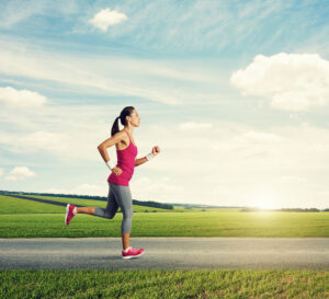 girl running on road - how long to become a better runner