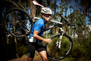 Young man running with a bike